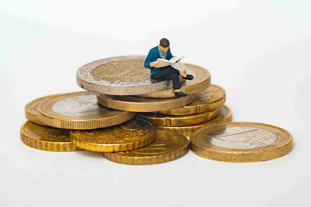 living generously man sitting on coins