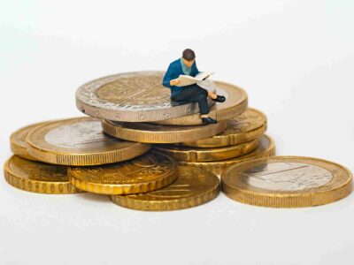 living generously man sitting on coins